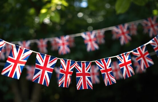 String of British flag buntings outdoor. Flags show patriotism. Decoration for national public holiday in the UK. Celebration event on street. Symbol of United Kingdom on garland. Party decor.