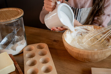 Little cute girl baking cookies in the kitchen. Homemade pastries. Cozy autumn.