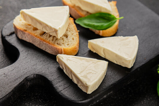 Processed cheese triangle spread portion size cheese for sandwich tasty snack fresh delicious gourmet food background on the table rustic food top view copy space