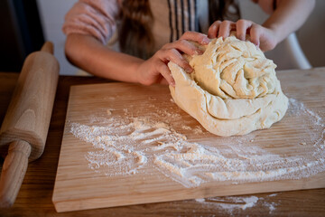 Little cute girl baking cookies in the kitchen. Homemade pastries. Cozy autumn.