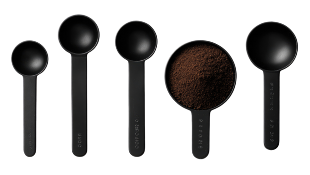 Black measuring spoons, various sizes, atop dark background.  Coffee grounds in central spoon