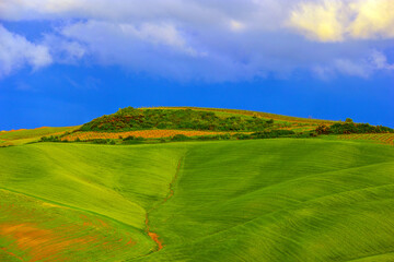 Early morning on countryside, Tuscany landscape in spring fields green meadows, Tuscany, Italy.