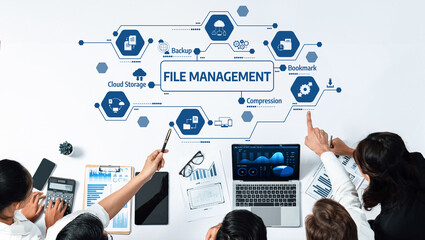 A diverse business team collaborates on innovative file management strategies using technology, showcasing data analysis and modern office tools for organizational success. Amity