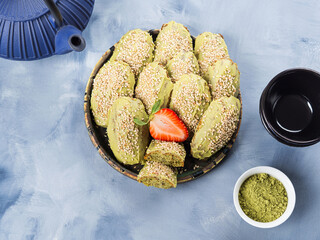 Matcha madeleine cookies with white chocolate frosting and sesame seeds