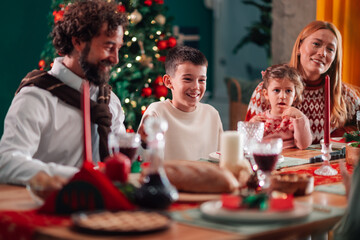 Family enjoying christmas dinner at home