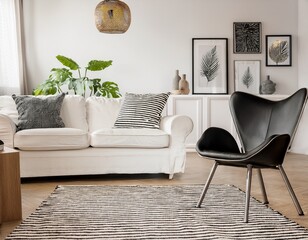 bright living room with a white sofa black chair and striped rug