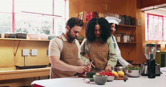 Couple, chef and cooking class with ingredients, help and bonding together in kitchen. Cutting, man and women with herbs, recipe and teaching with relationship, growth and gourmet cuisine with advice