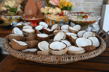 luxurious tropical buffet table arrangement, full spread of exotic food and coconuts, vibrant catering service display with flowers, south american gastronomy feast setup


