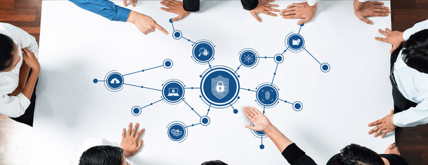 A group of professionals engaged in a collaborative discussion about security strategies, using digital elements to visualize connections and data management concepts. Amity