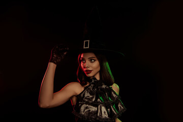 Fototapeta premium Stylish witch in dark attire with a spellbinding look, perfect for Halloween themes and mysterious autumn photography