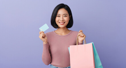 Happy woman with shopping bags and credit card