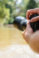 Photographer holding camera in nature
