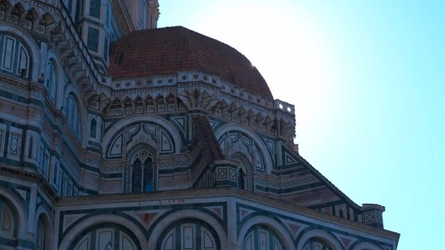 Florence cathedral dome, majestic architecture italy. Sunlight illuminates the intricate details of brunelleschi's dome, showcasing the polychrome marble facade and the architectural grandeur