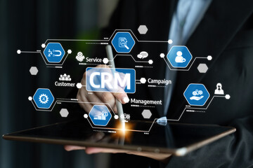 A business professional interacts with a tablet showcasing customer relationship management features, highlighting integrated campaigns and service management tools for efficiency. Tessel