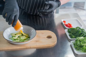 The chef prepares a salad. 
