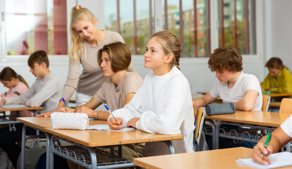 Student is sitting test and answer about task in the classroom.