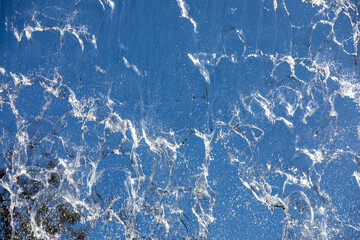 
Falling water on blue background, close-up photo