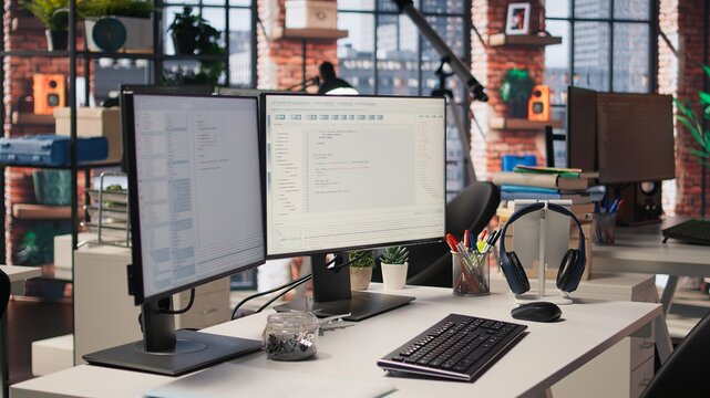 Empty startup office with PC on desk to be used by programmers building scalable solutions for businesses. AI industry startup workspace leveraging machine learning technology
