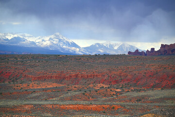arches-national-park-utah-snow-covered-peaks-contrasting-red-desert