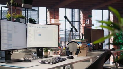 Empty AI industry startup workplace leveraging machine learning technology. Company office with PC on desk to be used by programmers building scalable solutions for businesses, trucking left shot