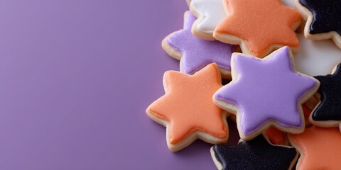 Close-up of baked treats with colorful icing and sparkling sugar, great for autumn or Halloween. (