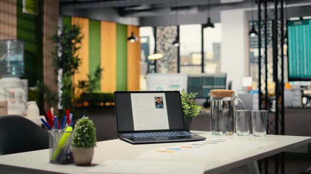Empty company space with a laptop showing CV applicant before job interview, space used for the recruitment process and reviewing qualifications or past work experience to align with vacancy.