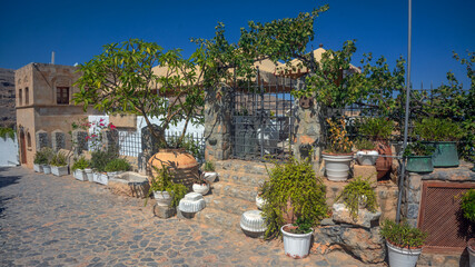 Traditional stone house with garden and potted plants