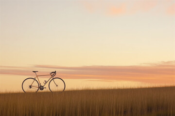 Obraz premium Bicycle silhouette against golden sunset sky over flat horizon landscape. Minimalist outdoor scene with single bike creating striking contrast with warm orange atmospheric sunset lighting.