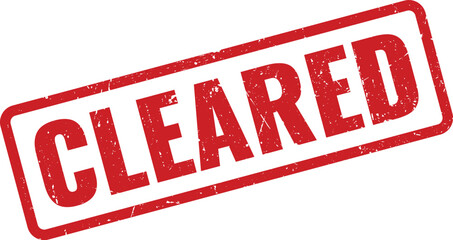 Red cleared rubber stamp with textured finish on a white surface, signifying a resolved or approved item
