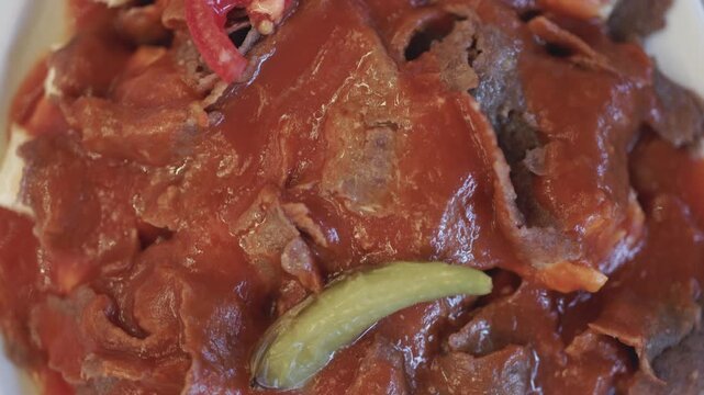 Close-Up of Turkish Iskender Kebab with Doner Meat on a White Plate
