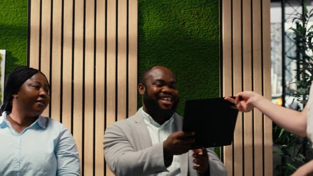 HR assistant brings registration forms papers to job seekers seated in line, job interview bureaucracy by organizing documents and resumes on trolley cart. Files details. Camera B.