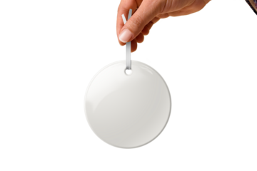 Hand holding Christmas round ceramic ornament or decoration with golden string mockup isolated on a transparent background, PNG. High resolution. Mockup, template ready for your design.