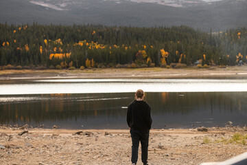 Man Walking in Front of Beaver Reservoir in the Rocky Mountains