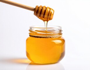 Dripping honey from dipper into a small glass jar