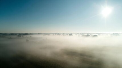 Luftbild vom Hegauvulkan Hohentwiel mit der oberen Festungsruine von der aufgehenden Sonne angestrahlt, die bei einer Inversionswetterlage aus dem Nebel herausragt