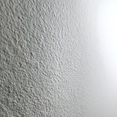 Abstract Rough Gray Wall Texture with Bright Gradient Light and Subtle Shadows.