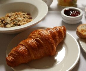 Fresh croissant, granola, and jam creating a delicious morning meal. Cotswolds countryside, England