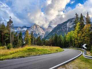 Idyllic and scenic view of an alpine winding road and rocky mountain peaks between Misurina and Auronzo. Dolomites, Italy