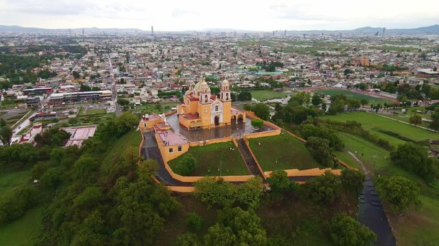 Cholula, Puebla, Mexico, aerial view of the Remedios Church on the top of the great pyramid, Popocatepetl volcano at the background