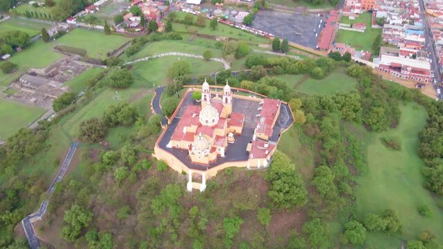 Cholula, Puebla, Mexico, aerial view of the Remedios Church on the top of the great pyramid, Popocatepetl volcano at the background