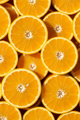 Top View of Halved Oranges – Realistic Juicy Citrus Halves Filling the Frame, Sunlit Summer Mood with Bright Warm Tones
