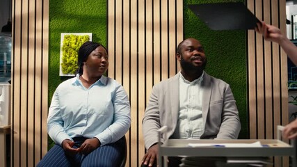 HR assistant brings registration forms papers to job seekers seated in line, job interview bureaucracy by organizing documents and resumes on trolley cart. Files details. Camera A.