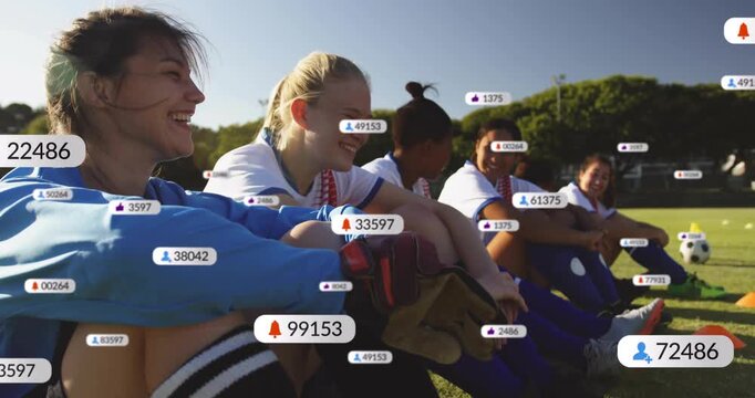 Soccer teammates on sideline seeing social media badges rising, capturing engagement on smartphone