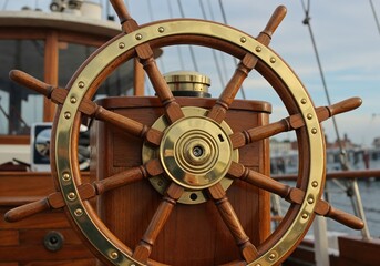 Nautical Navigator's Wheel: A close-up view of a classic ship's wheel, crafted from rich wood and accented with polished brass, suggesting adventure and maritime heritage. 