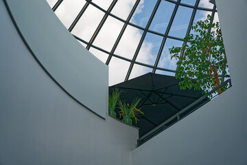 White concrete walls dome and potted plants under black canopy