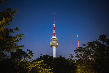 Night view of N Seoul Tower and stars in Namsan, Seoul, surrounded by trees, South Korea