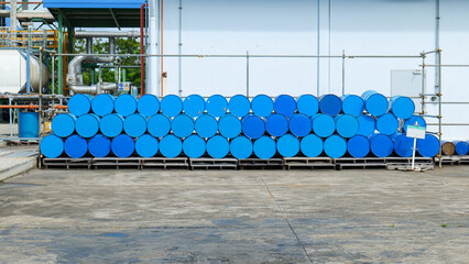 Stacked chemical storage tanks arranged in multiple layers in a storage yard at a chemical factory, representing industrial safety,