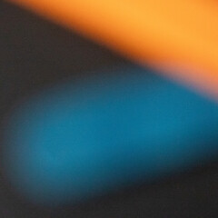 Blurred Orange and Blue Streaks on Dark Background