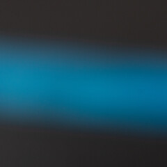 Blurred Blue Light Streak on Dark Background — Abstract Motion and Glow Concept