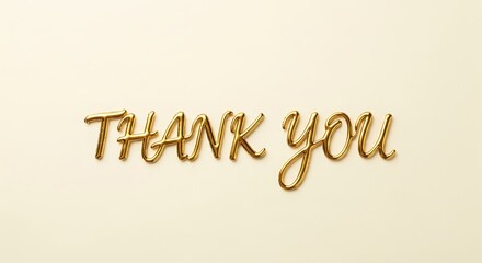 Thank you message in golden cursive letters against a light cream colored background flat lay style shot